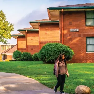 Students walking near campus townhouses in the Fall.